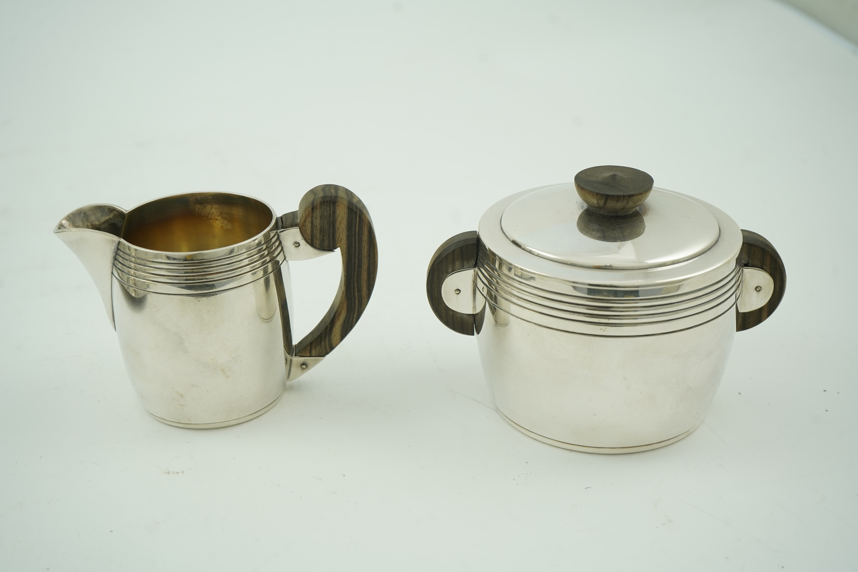 An Ercuis Art Deco silver plated Macassar handled four piece tea or coffee set
